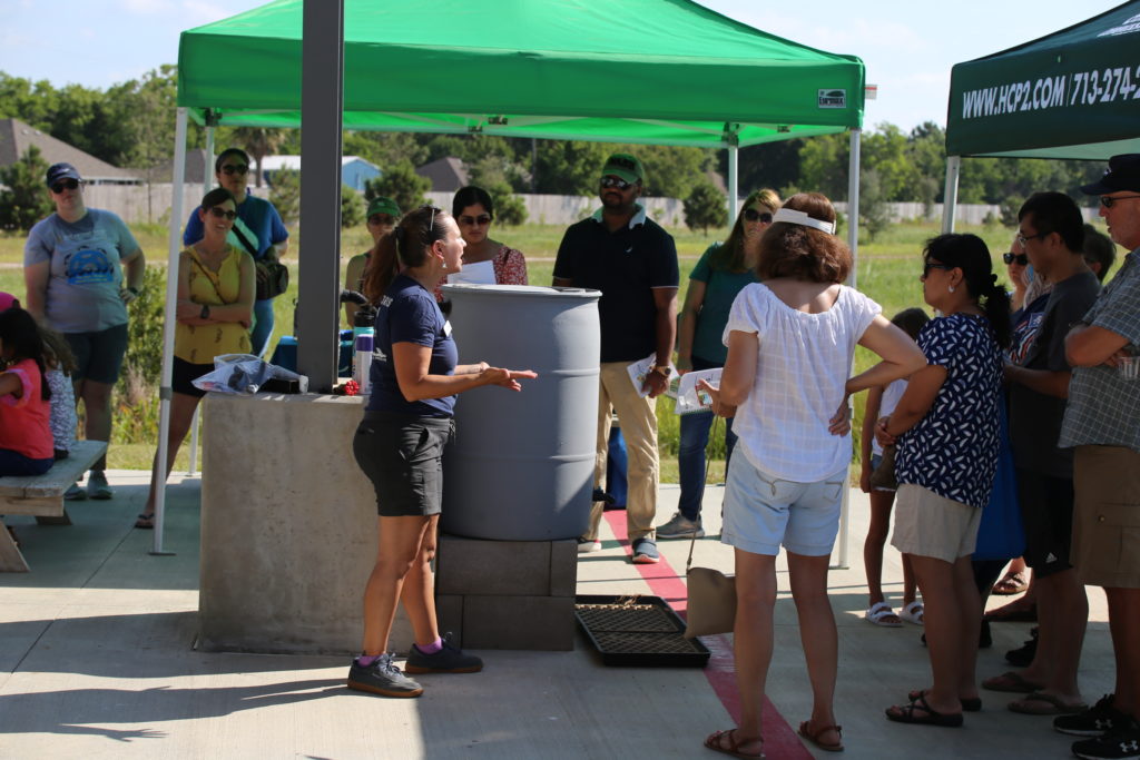 Rain barrel workshop participants under tents