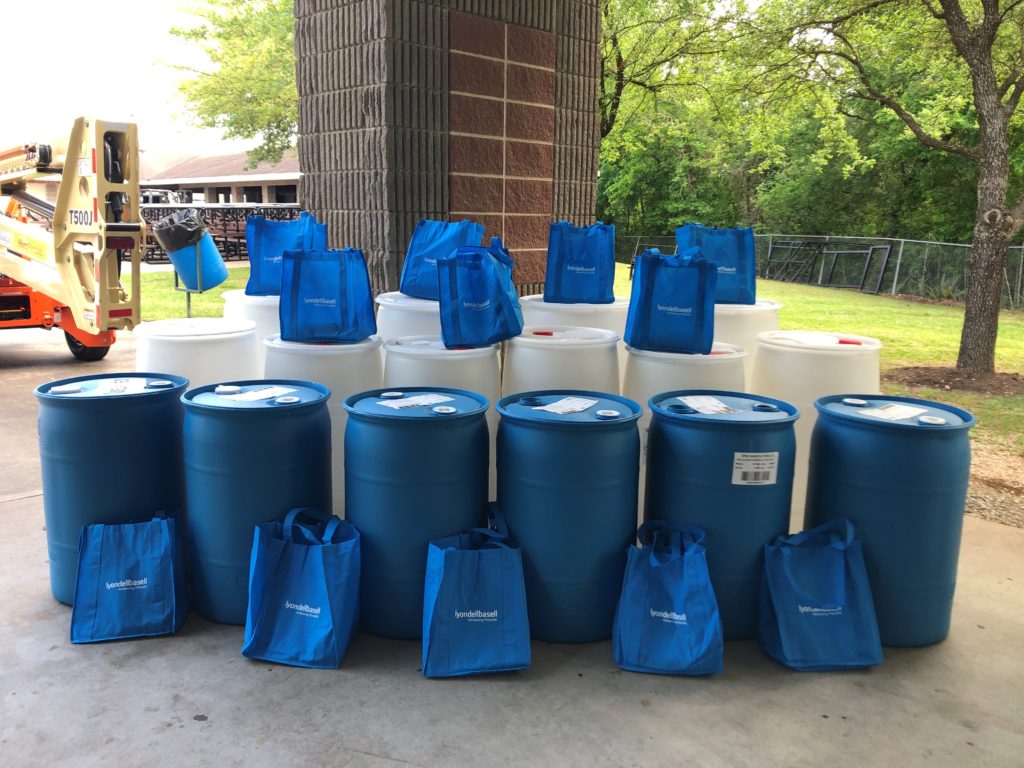 White and blue rain barrels lined up for display 