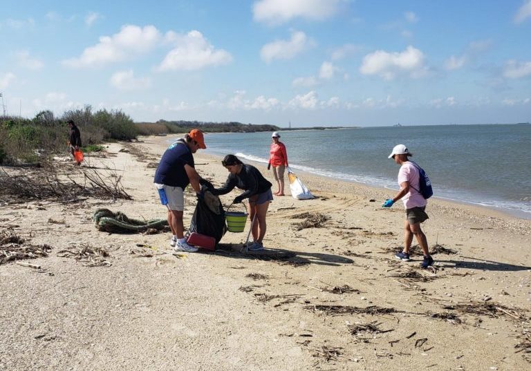 Volunteers collecting trash along Galveston Bay